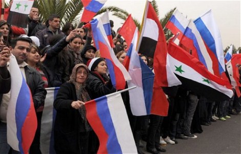 syria pro government protesters wave russian flags